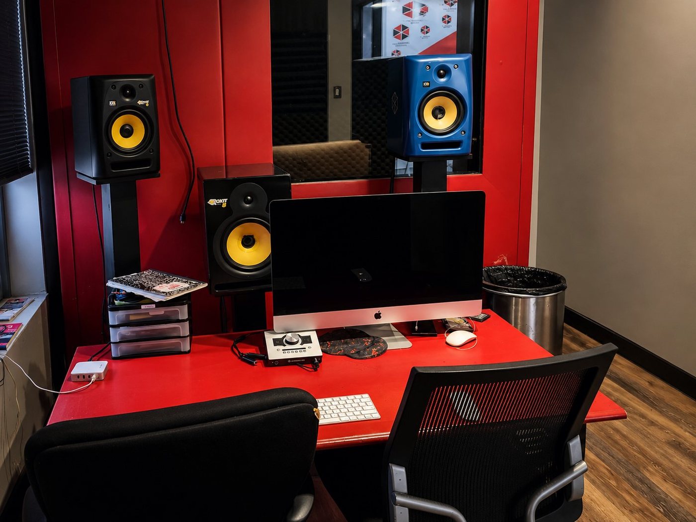 B Room control room with red desk, iMac and studio monitors