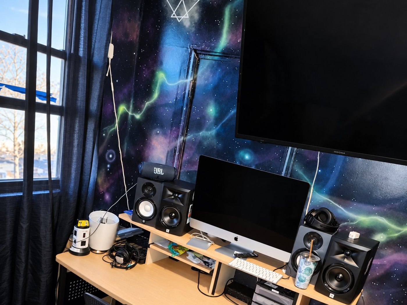 C Room control room with desk, iMac, studio monitors and galaxy wall