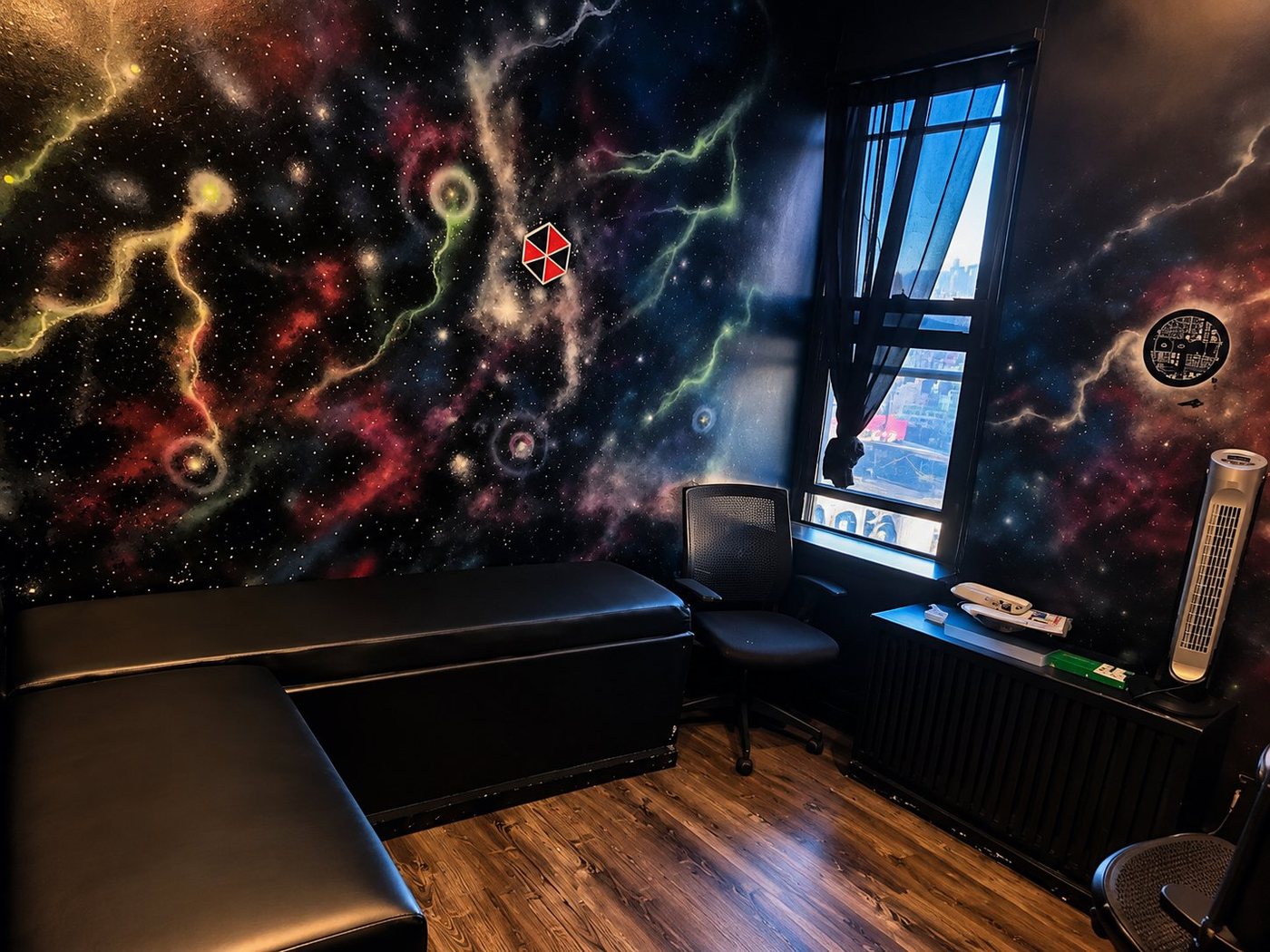 C Room lounge with galaxy walls, black seating and window light